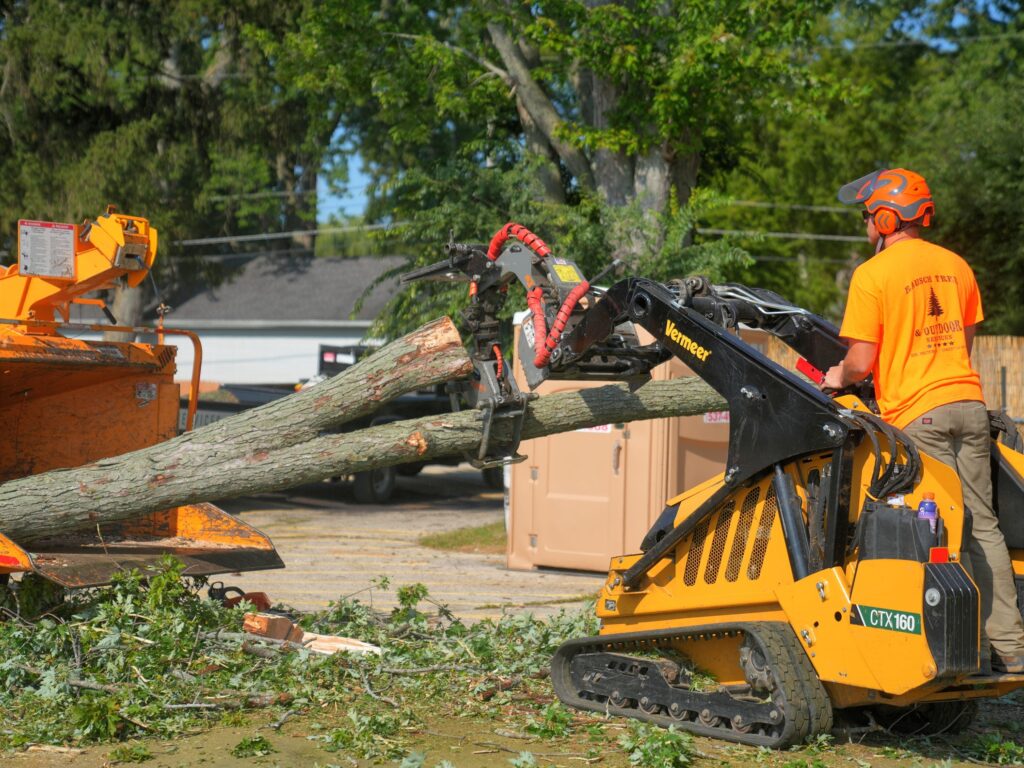 Tree services loading excess tree parts to equipment